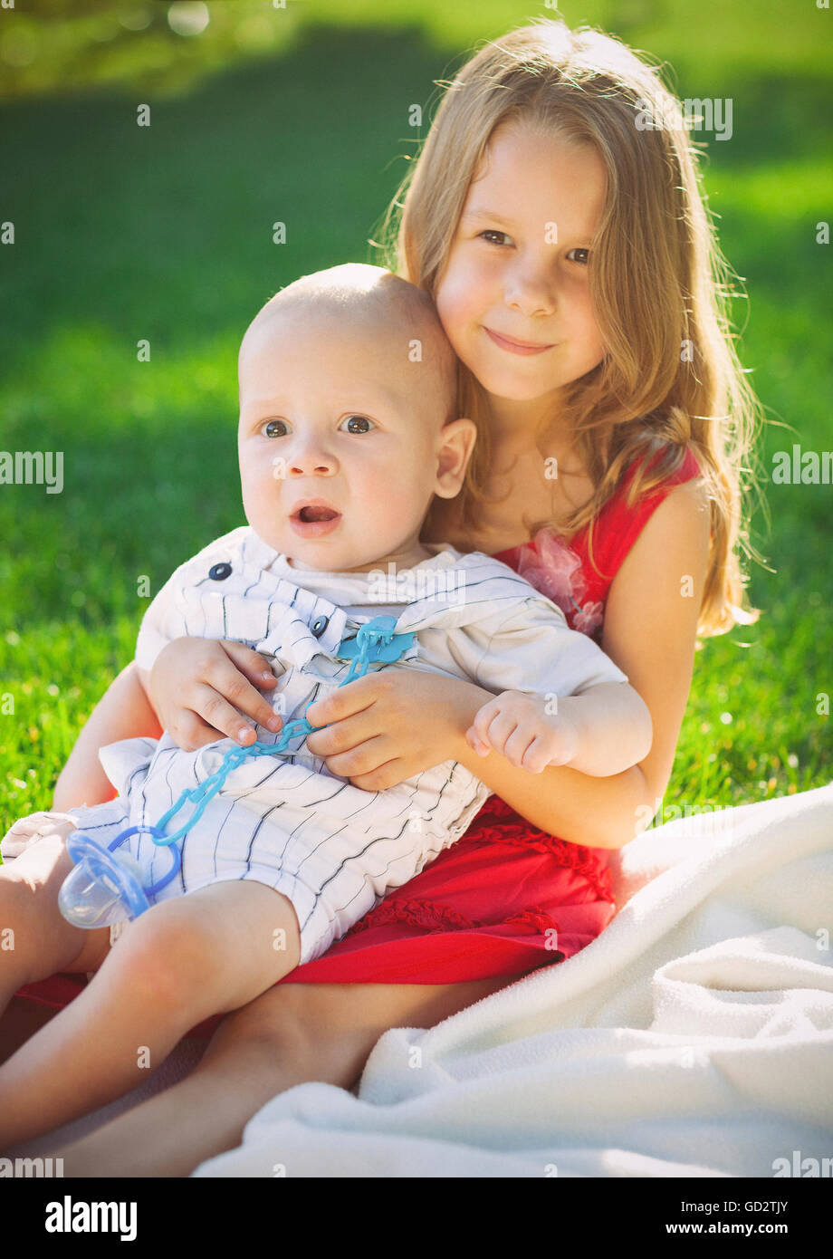 Two children baby brother and sister on green meadow. Summer park Stock ...