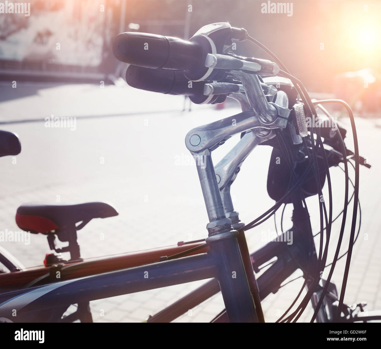 Station of urban bicycles for rent downtown. Green sustainable ecological public transport. Healthy lifestyle. Close up. Sunset Stock Photo