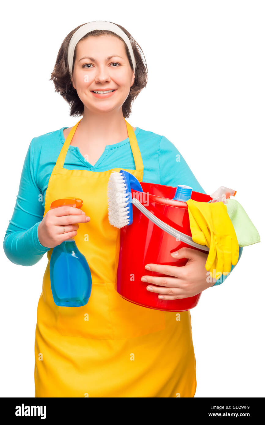 housewife posing with cleaning materials and a bucket on a white background Stock Photo