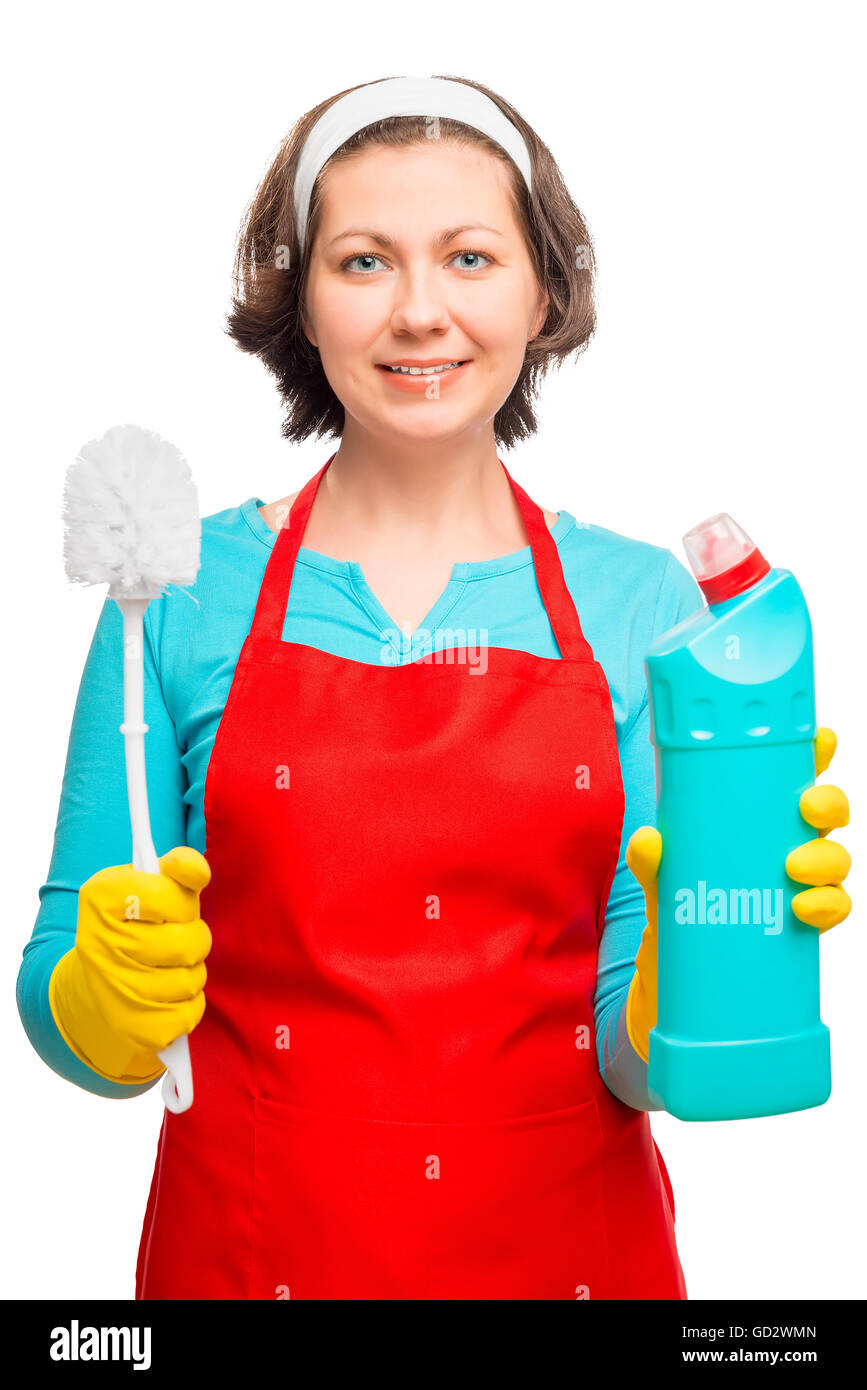 female in an apron holding a brush to clean the toilet and disinfectant ...