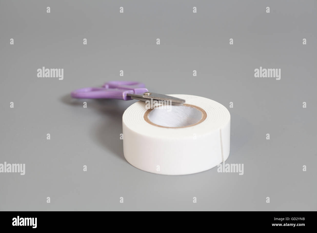 Scissors And Roll Of Duct Tape isolated on gray background Stock Photo