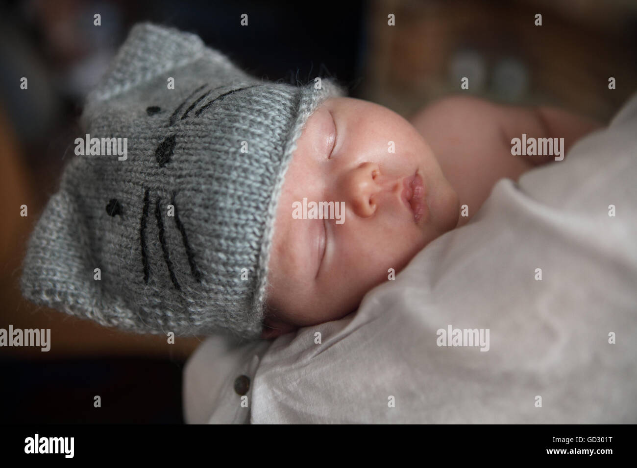 Baby boy falling asleep in the arms of her mother Stock Photo Alamy