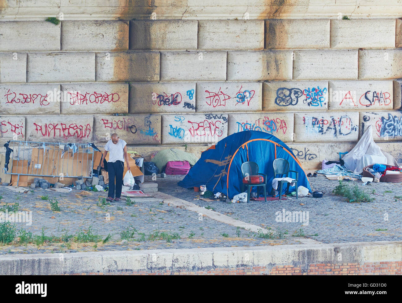Homeless man and tent under bridge Rome Lazio Italy Europe Stock Photo