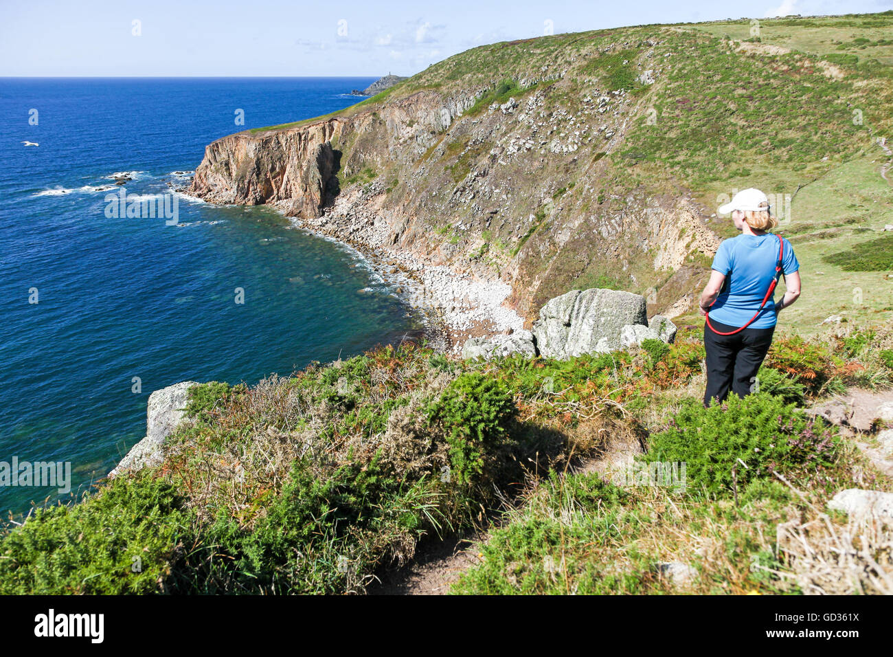 A woman looking out to sea at Tregiffian Vean cliff near to Sennen Cove Cornwall England UK Stock Photo