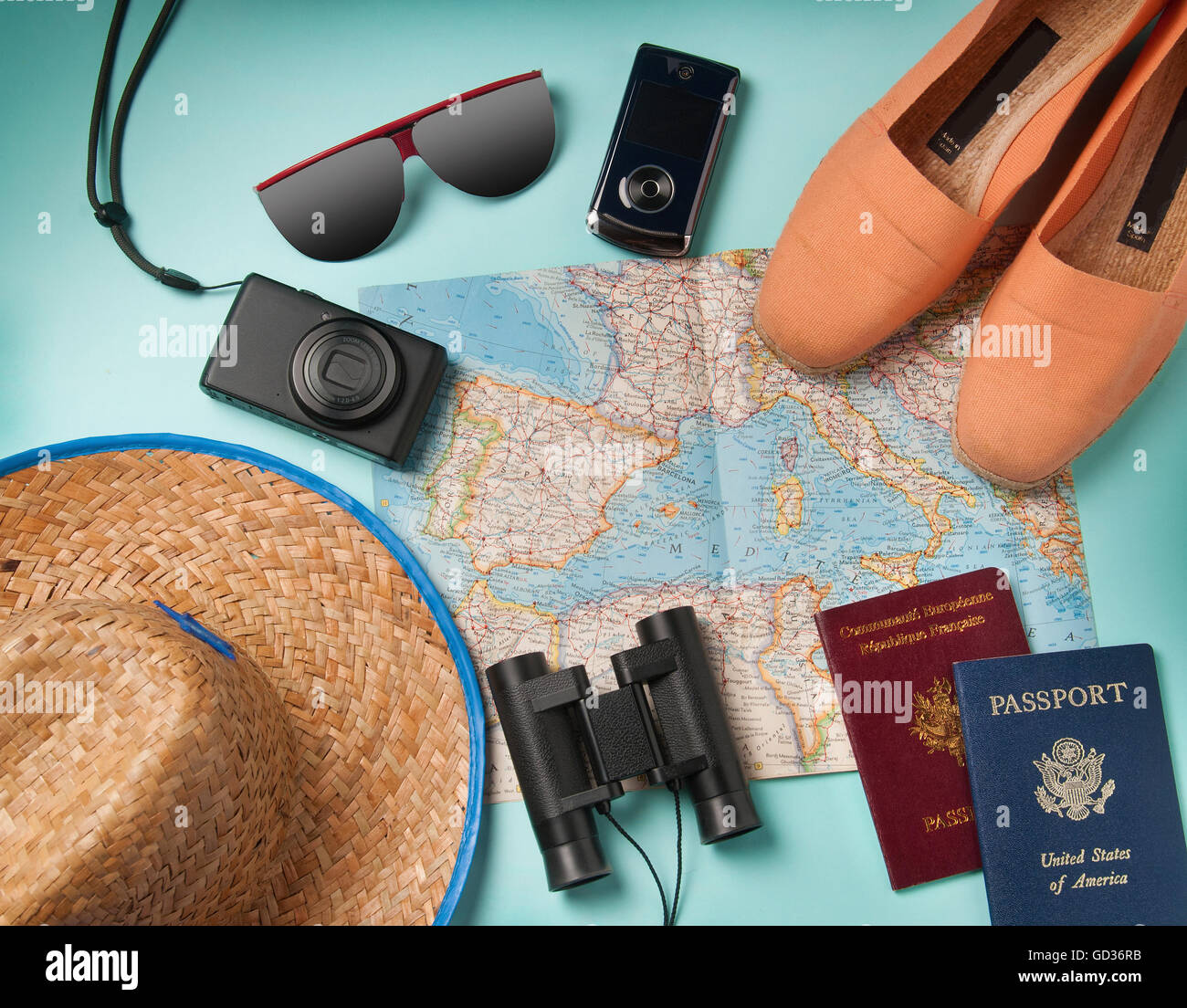 summer vacation, tourism and objects concept - close up of clothes, camera, binoculars, passports and travel map Stock Photo