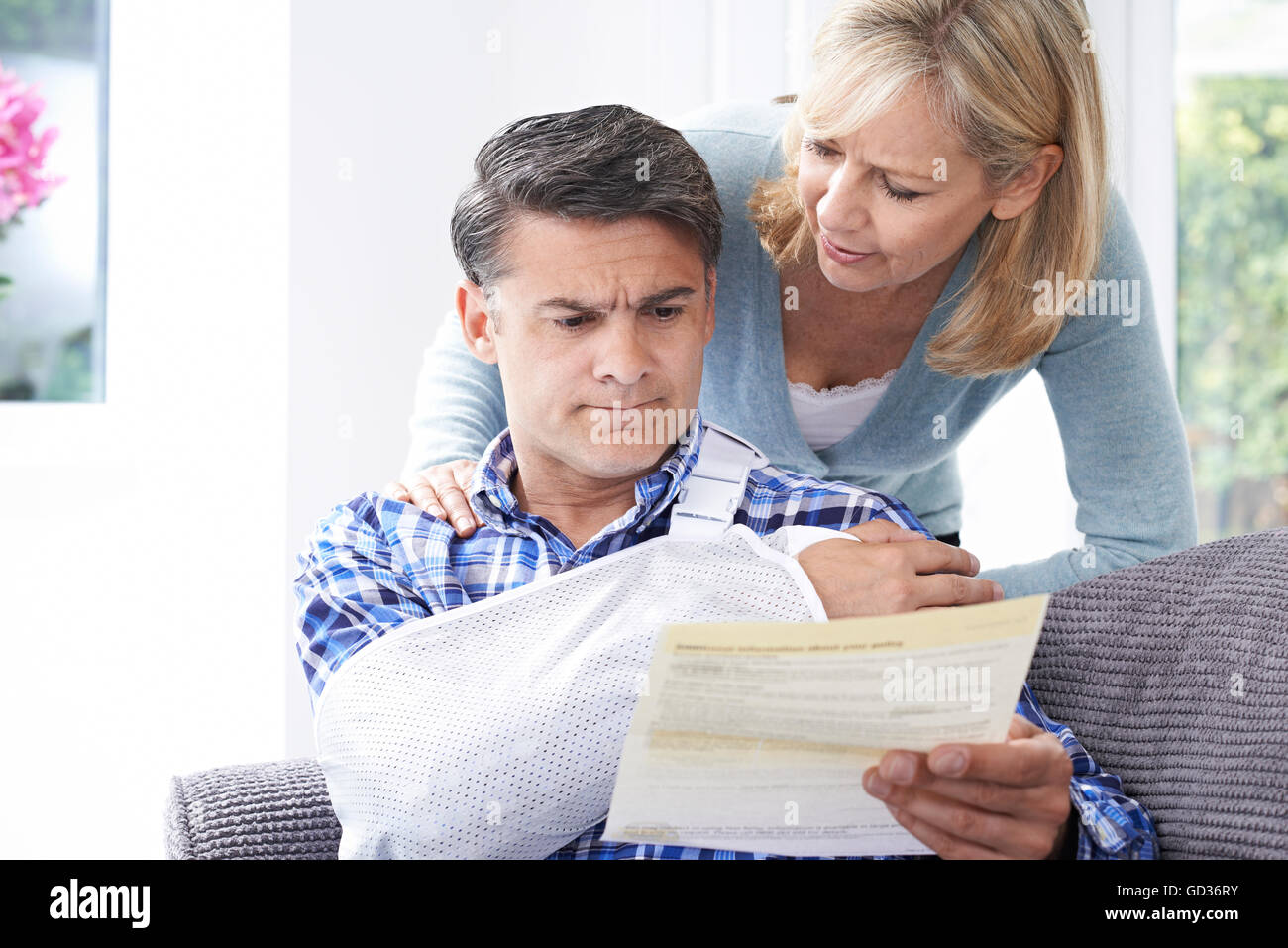 Couple Reading Letter About Husband's Injury Stock Photo