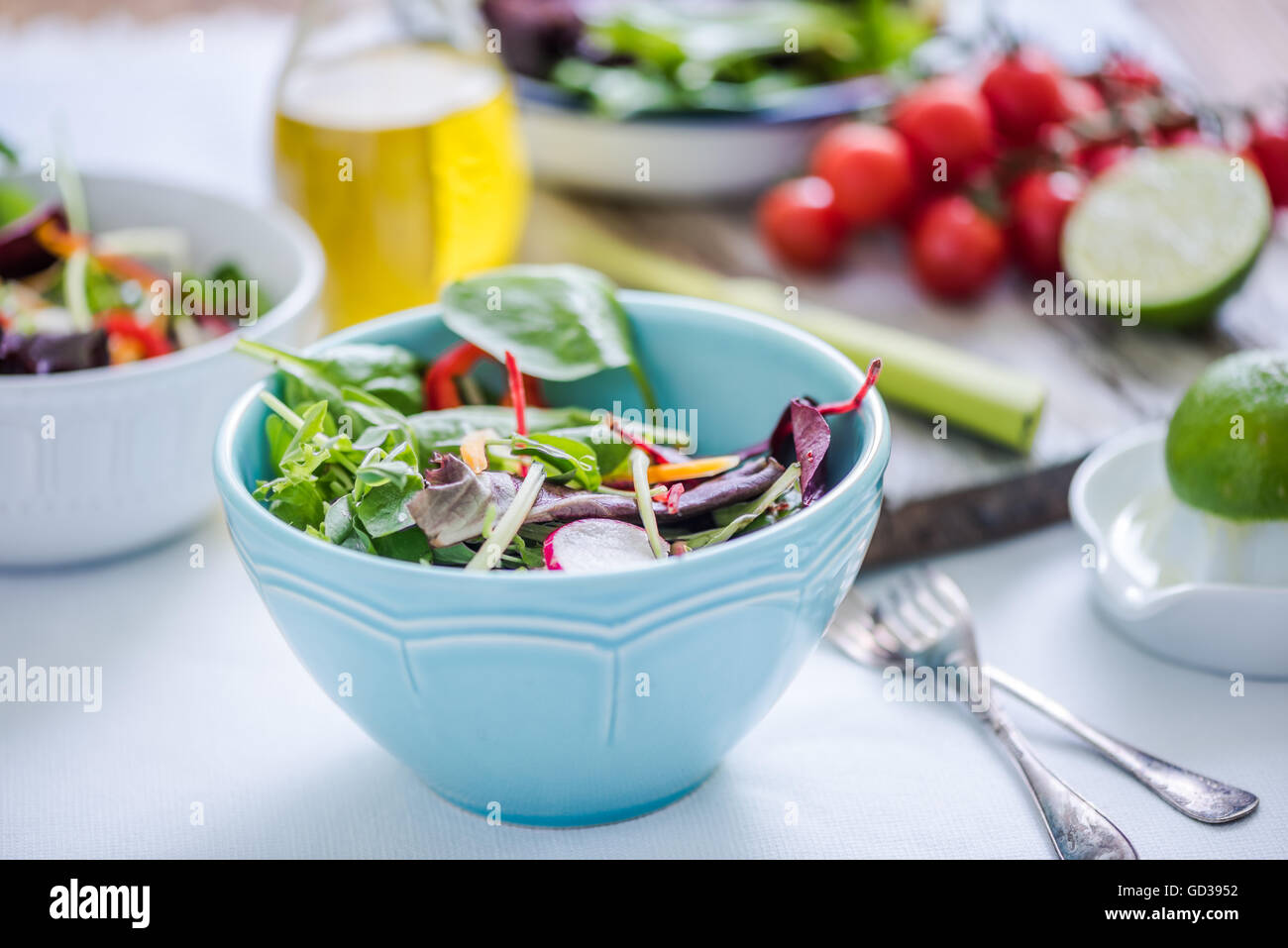 vibrant crunchy salad in bowl on bright cloth Stock Photo