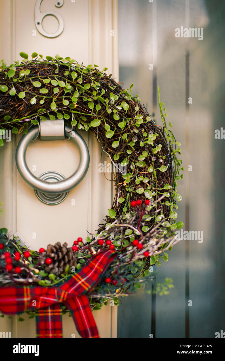 Christmas decorations. A Christmas wreath with a red bow on the front ...