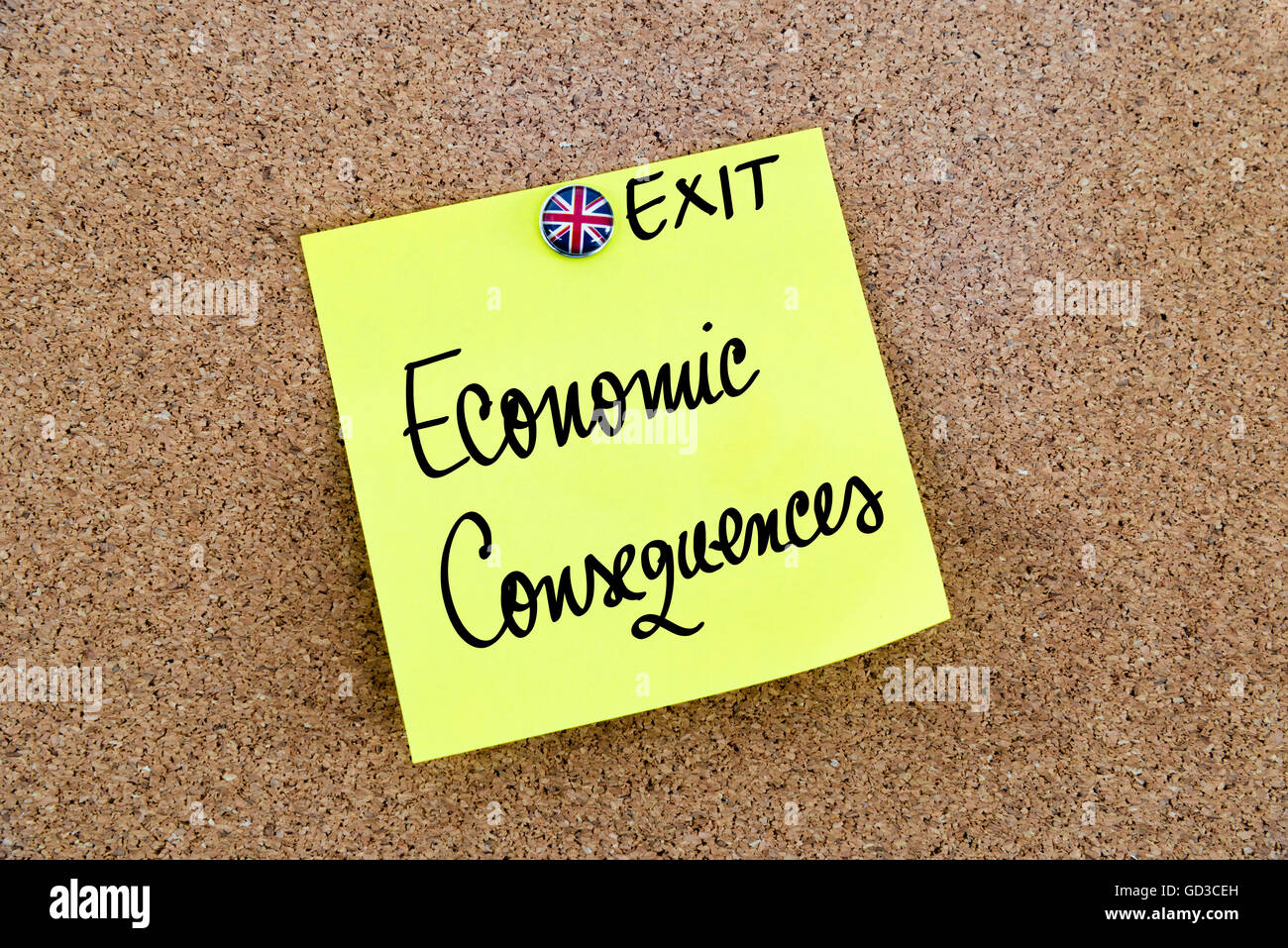 Yellow paper note pinned on cork board with Great Britain flag thumbtack, written text ECONOMIC CONSEQUENCES, United Kingdom exit from European Union Stock Photo