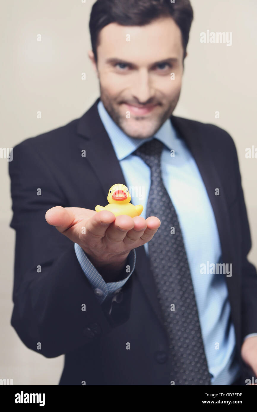 A young man with a yellow rubber duck Stock Photo - Alamy