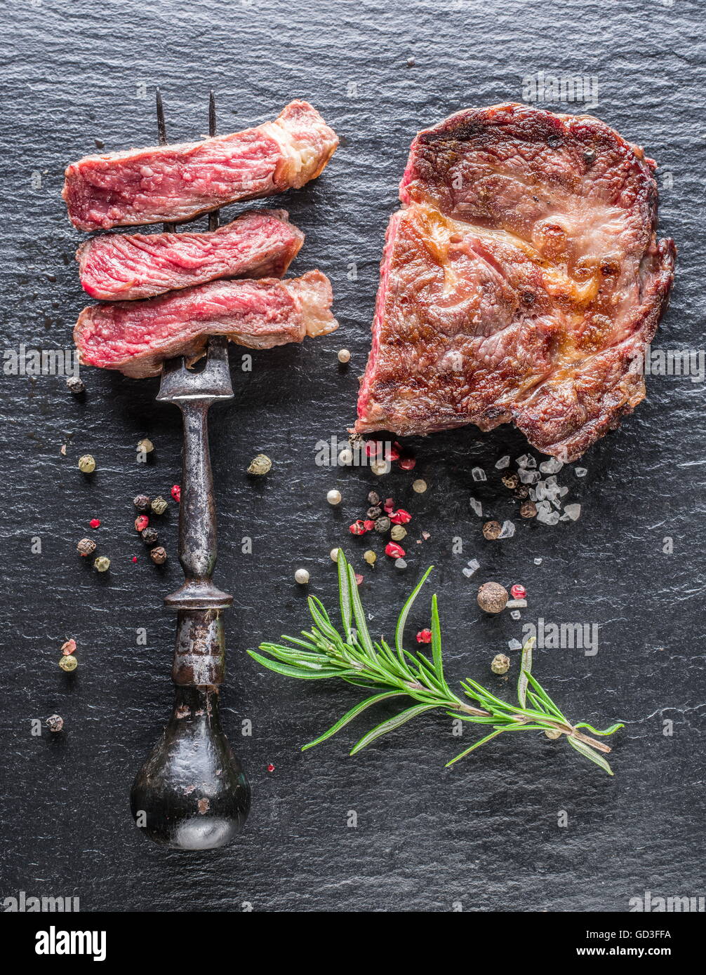 Medium Rib eye steak with spices on the graphite tray Stock Photo - Alamy