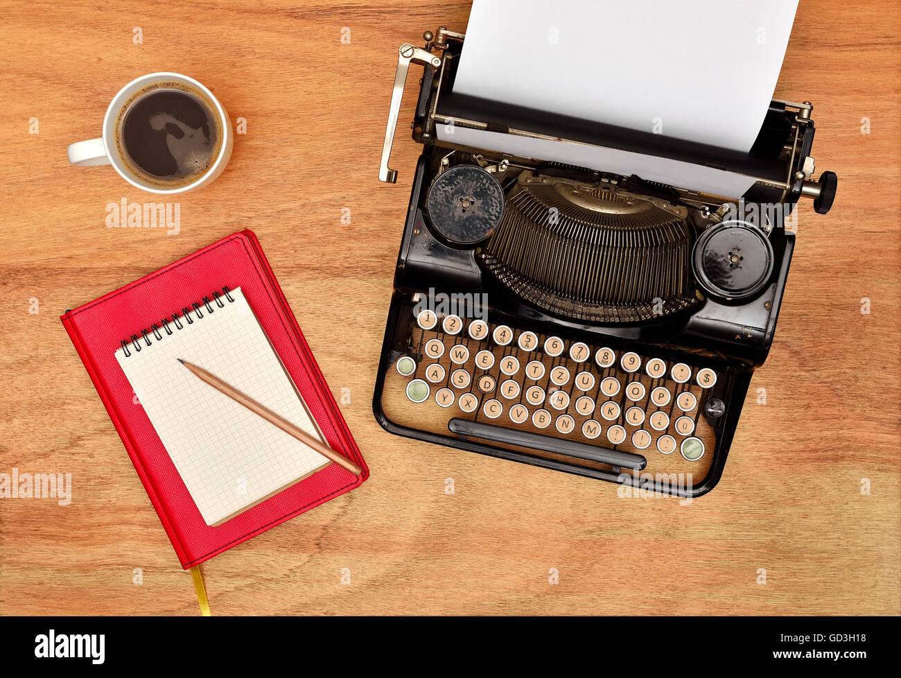 Vintage typewriter. Cup, pencil and red notebook Stock Photo - Alamy