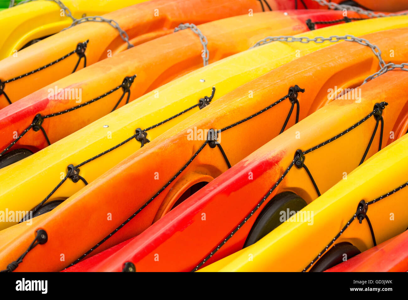 Colorful kayaks lying on their side at a kayak rental place at Lake