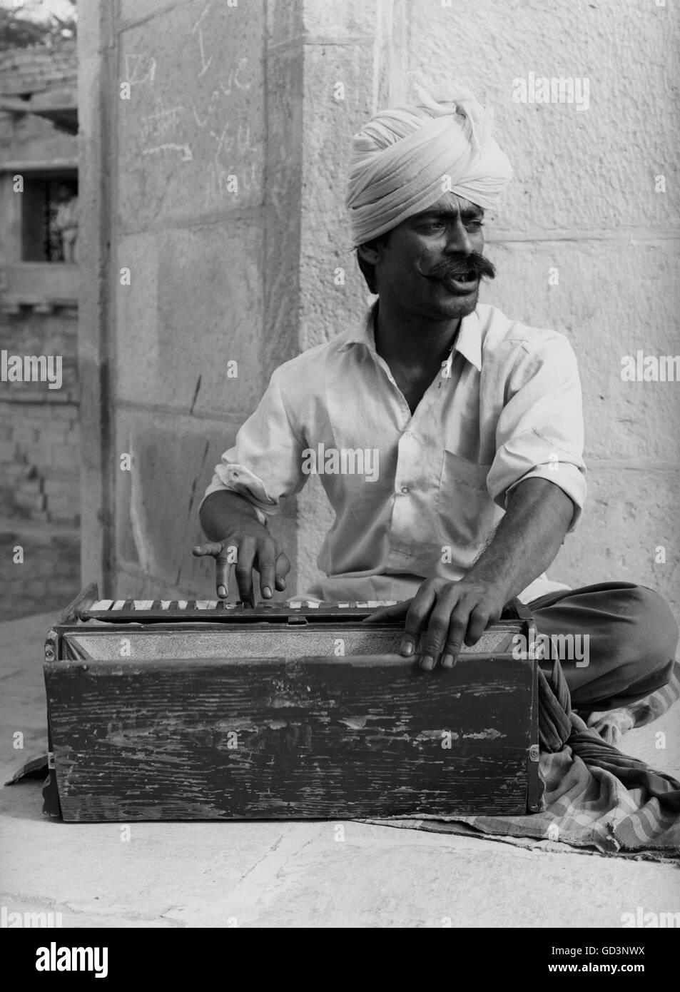 Man playing harmonium Stock Photo