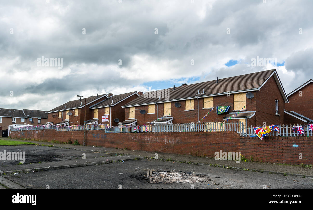 Belfast, UK. 11th July, 2016. Houses boarded up next to Loyalist bonfire in Shankill Road area of Belfast. Credit:  DMc Photography/Alamy Live News Stock Photo