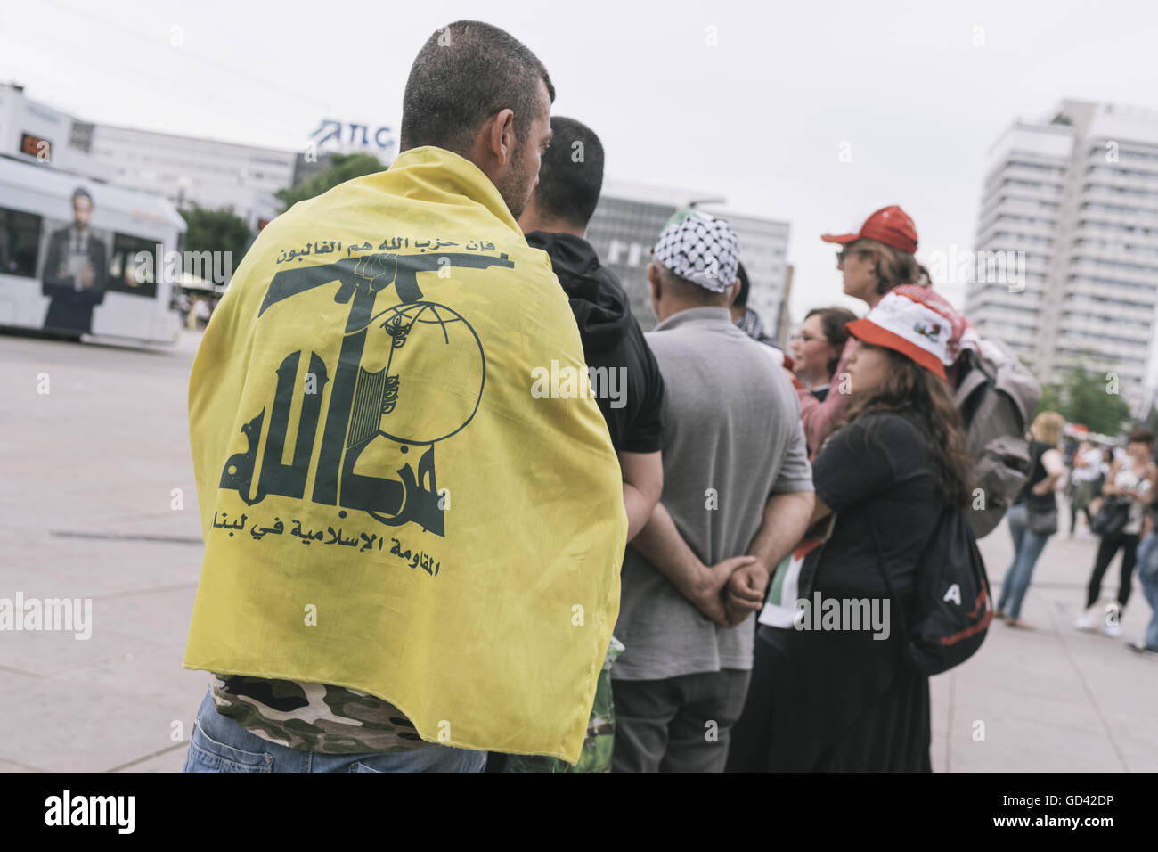 Berlin, Berlin, Germany. 12th July, 2016. A protester wearing a Hizbollah Flag during the Anti Israel protests organized by Martin Lejeune in Berlin held under the motto '10. Jahrestag Israelischer Angriff auf Libanon und sein Volk! [10th Anniversary of Israeli attack on Lebanon and its people! Credit:  Jan Scheunert/ZUMA Wire/Alamy Live News Stock Photo