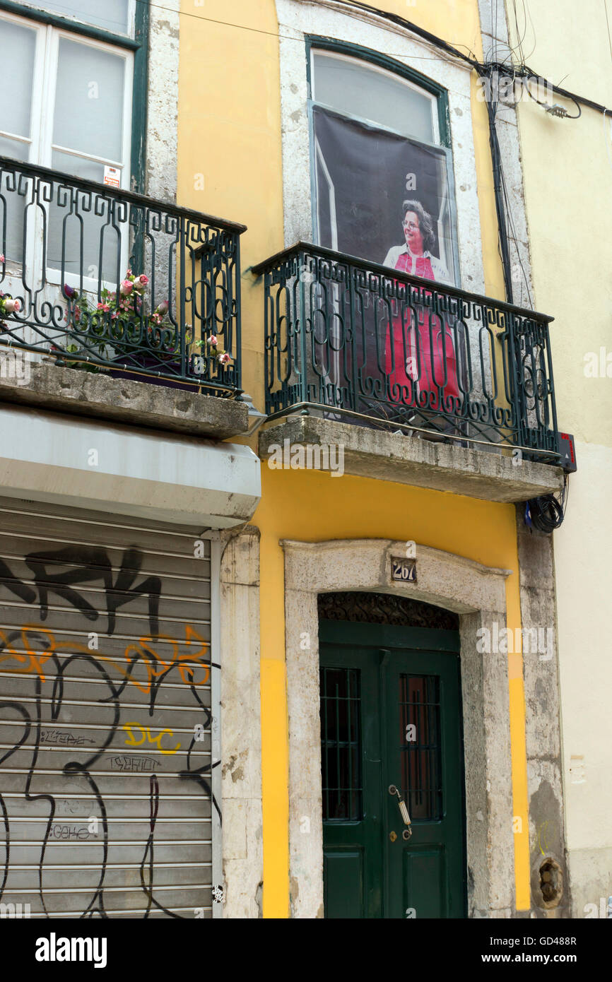 Large poster of a woman at a balcony in Lisbon, Portugal Stock Photo