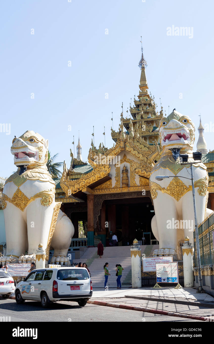 The Southern stairway of the Shwedagon Pagoda, in Yangon (Myanmar) with its couple of Chinthes which are standing guard. Stock Photo