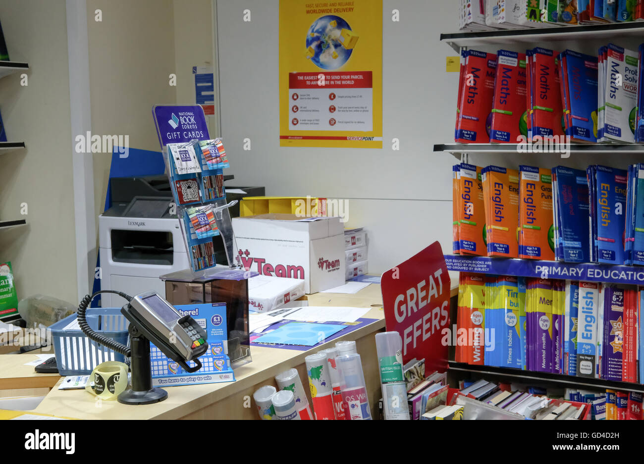 Retail service area of a high street newsagent type company. In view is a PDQ machine and various retail products, books etc. Stock Photo