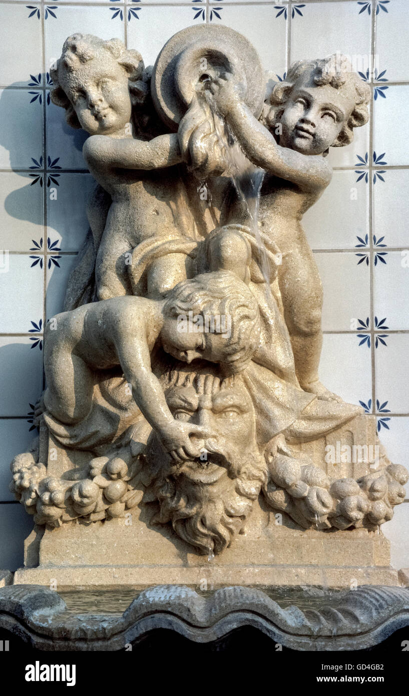 A trio of cherubs antagonize the Devil in this charming sculptured outdoor water fountain on the grounds of hotel in Beverly Hills, California, USA. Stock Photo