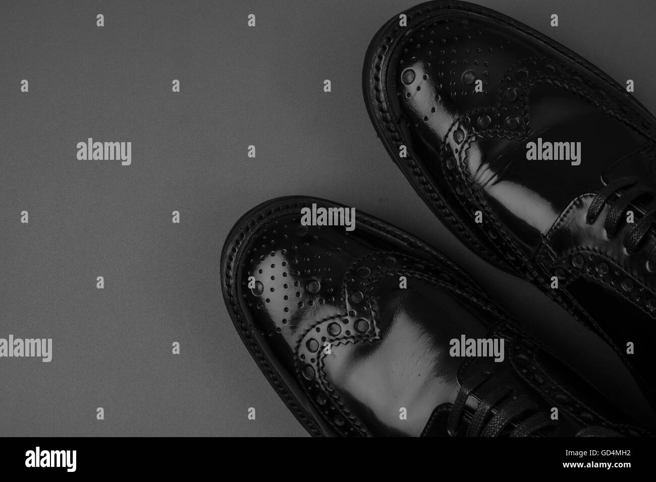 The pair of black leather shoes on a black background Stock Photo