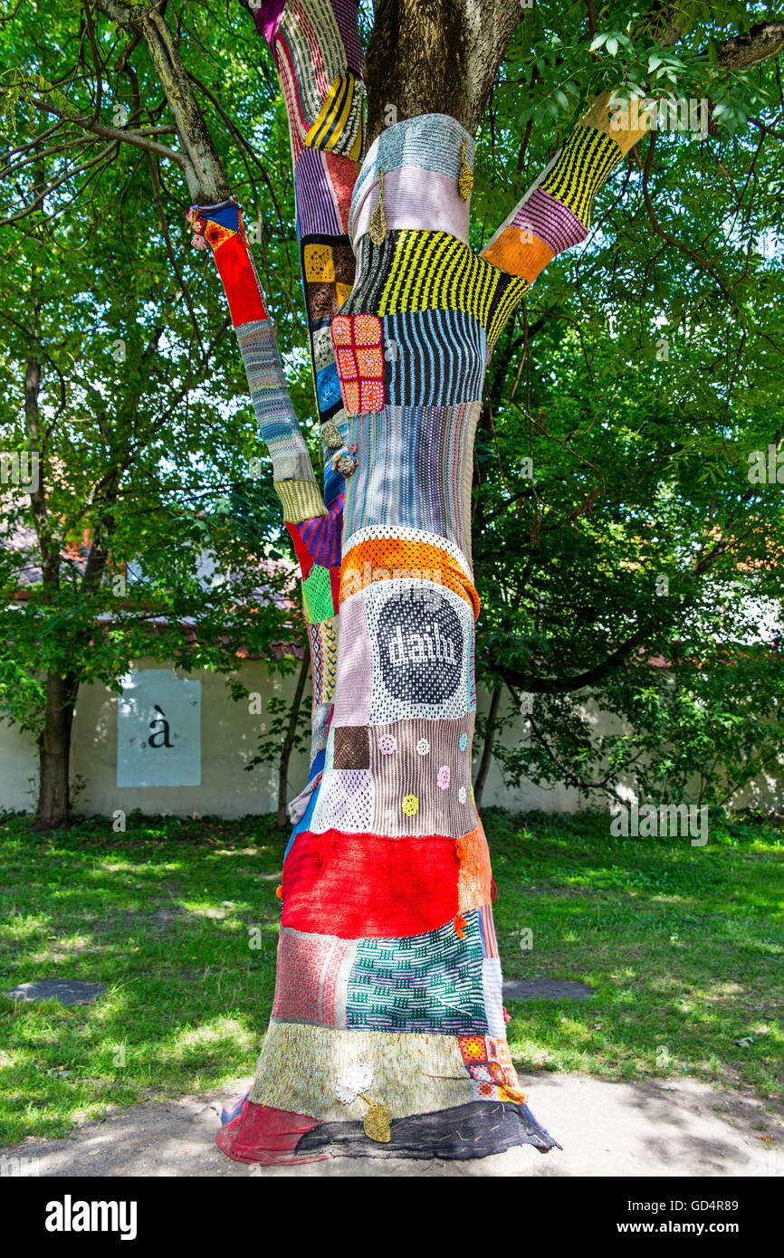 fine arts, textiles, crochet around trees in the old town of Vilnius, Lithuania, Artist's Copyright has not to be cleared Stock Photo