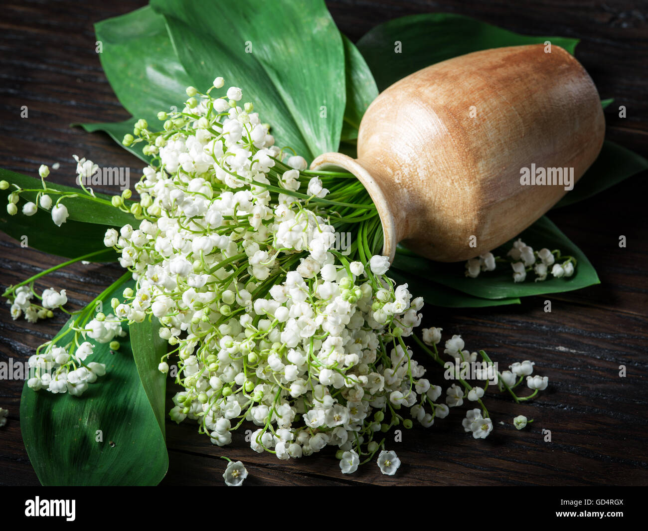 Lily of the valley bouquet on the wooden table. Stock Photo