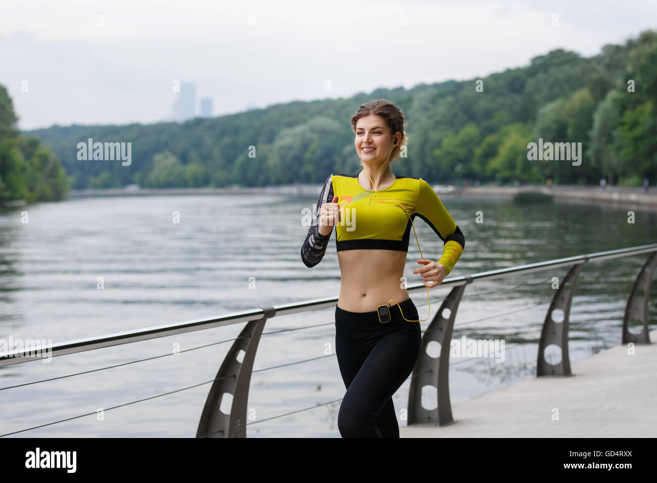 Young sporty girl running in park Stock Photo - Alamy
