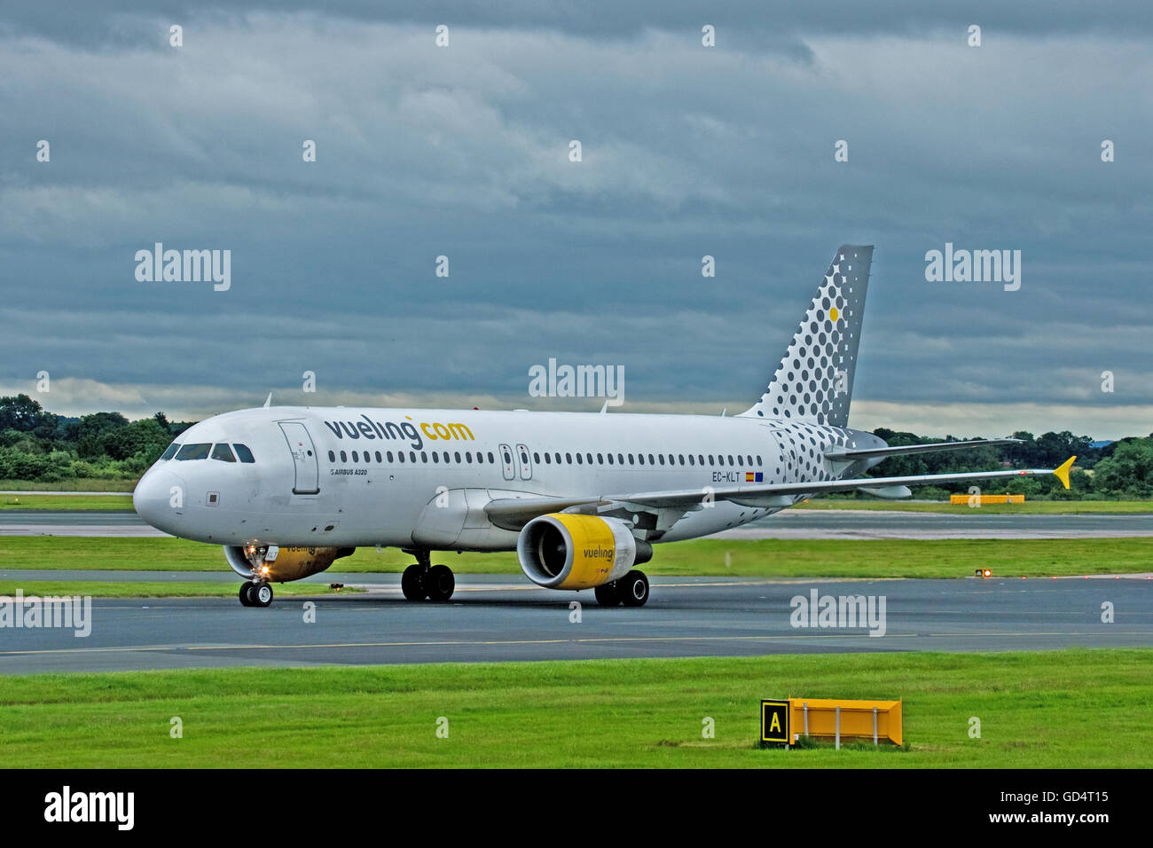 Vueling Airlines bringing a little colour to a grey day at Manchester Airport Stock Photo
