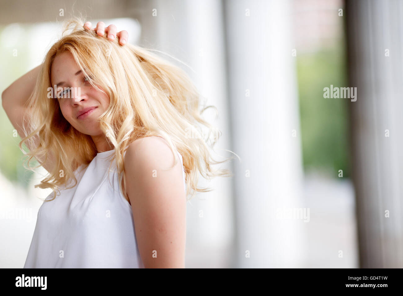 Young woman with long blonde curly hair Stock Photo - Alamy