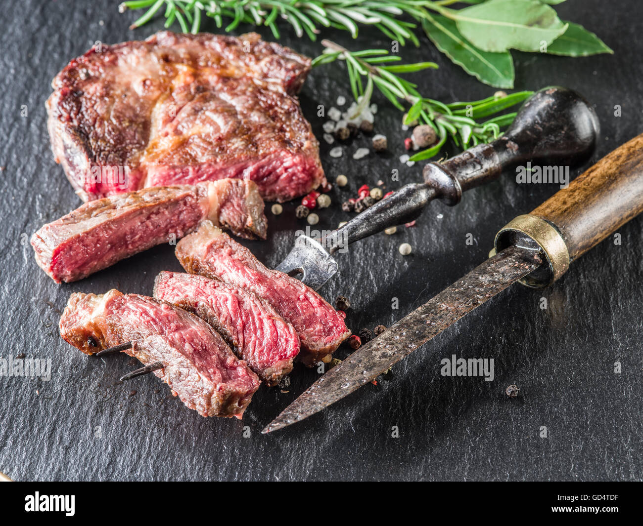 Medium Rib eye steak with spices on the graphite tray Stock Photo - Alamy