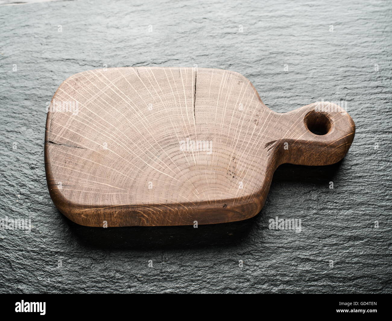Empty chopping wooden board on the graphite background. Stock Photo