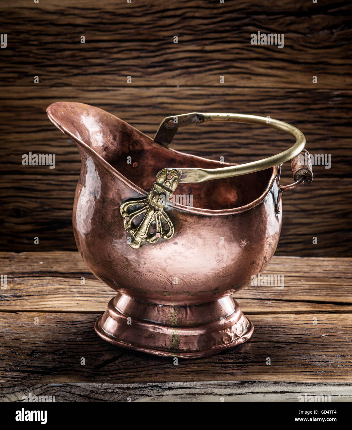 Empty brazen bucket on the wooden table. Stock Photo