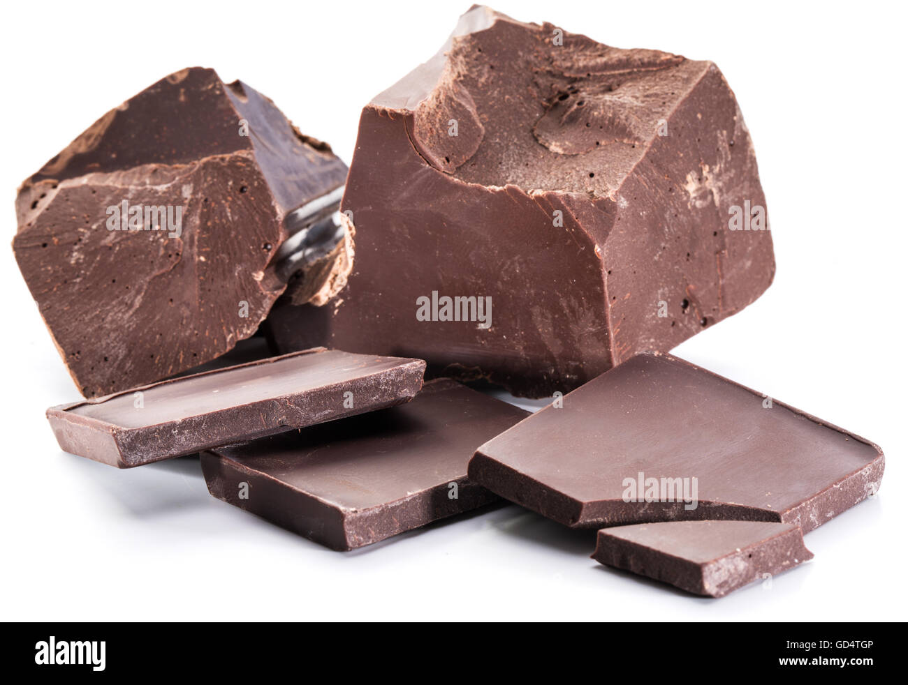 Chocolate blocks and pieces of chocolate bar isolated on a white background. Stock Photo