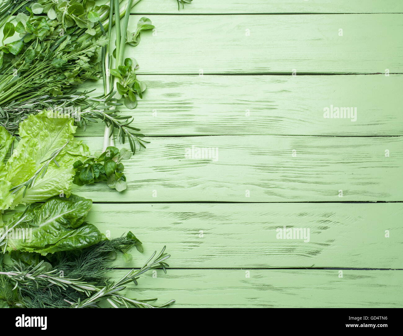 Green herbs on the green wooden background. Stock Photo