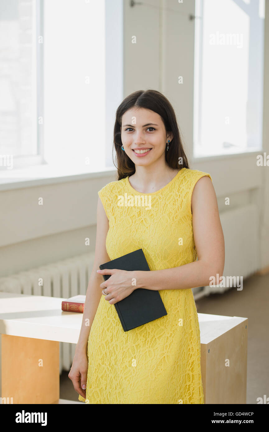 Happy young smiling student girl with book Stock Photo - Alamy