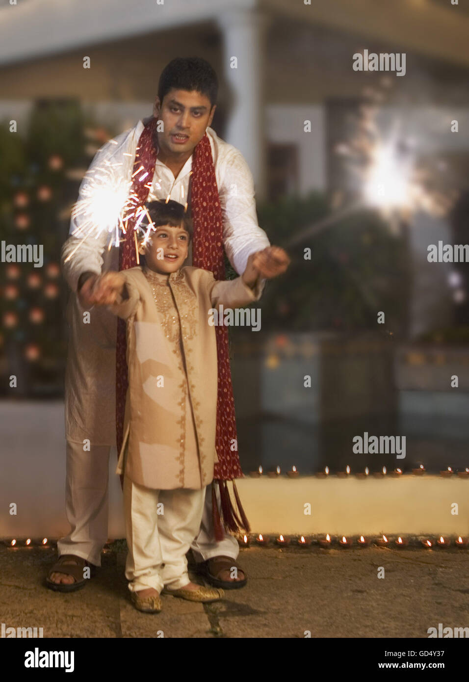 Father and son with fireworks on Diwali evening Stock Photo