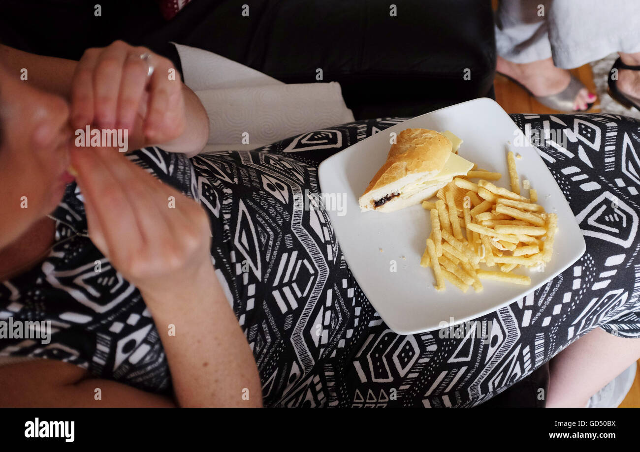 Young pregnant woman eating unhealthy diet of white bread cheese ... Young pregnant woman eating unhealthy diet of white bread cheese ...