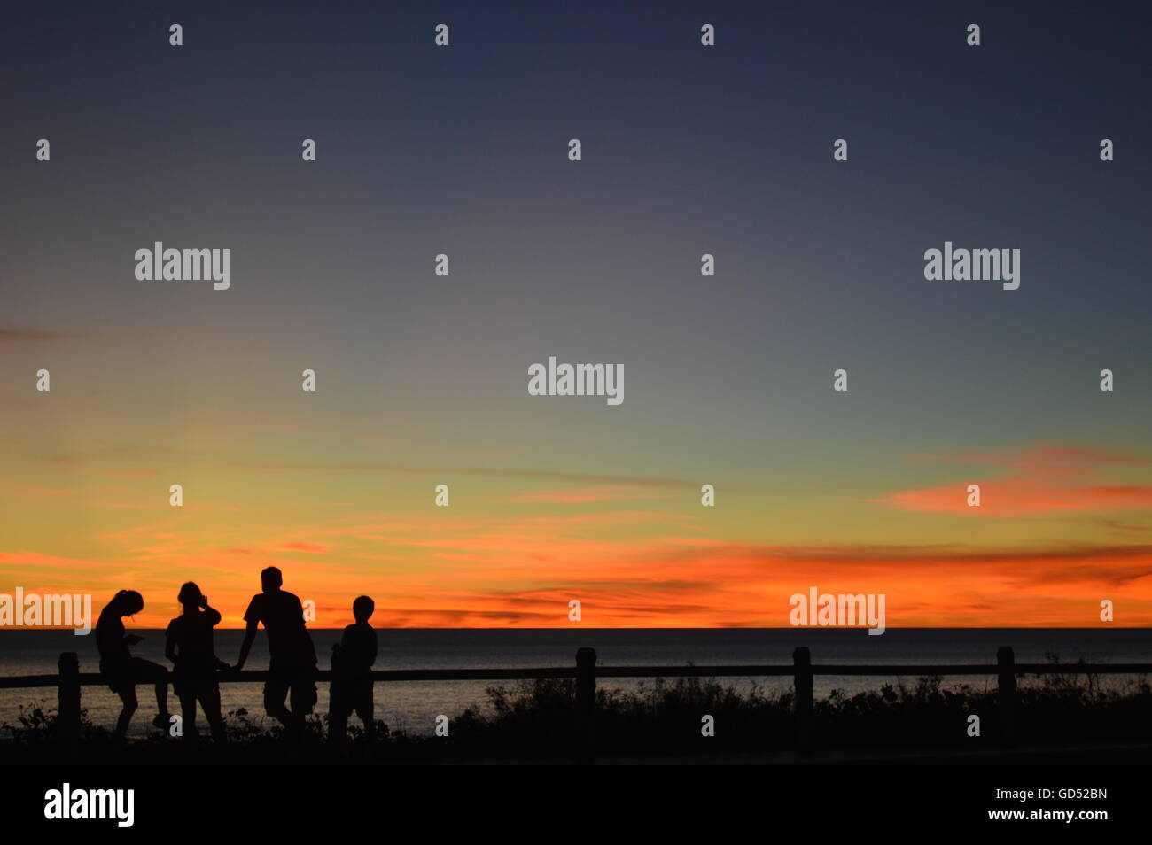 Friends watching the sunset at Cable Beach - Broome, Western Australia Stock Photo