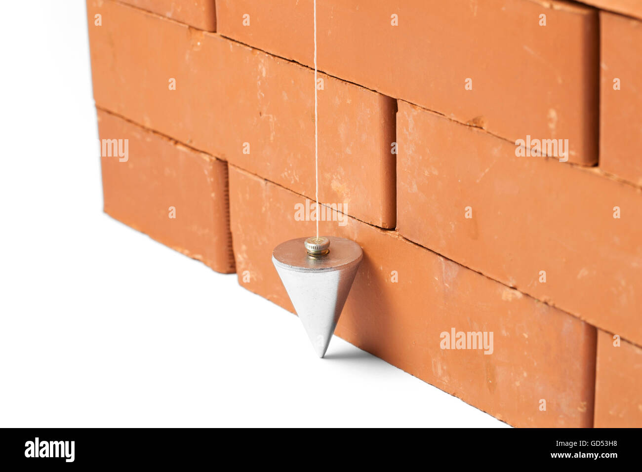 Bricks in masonry with touched plum bob for vertical line isolated on white background Stock Photo
