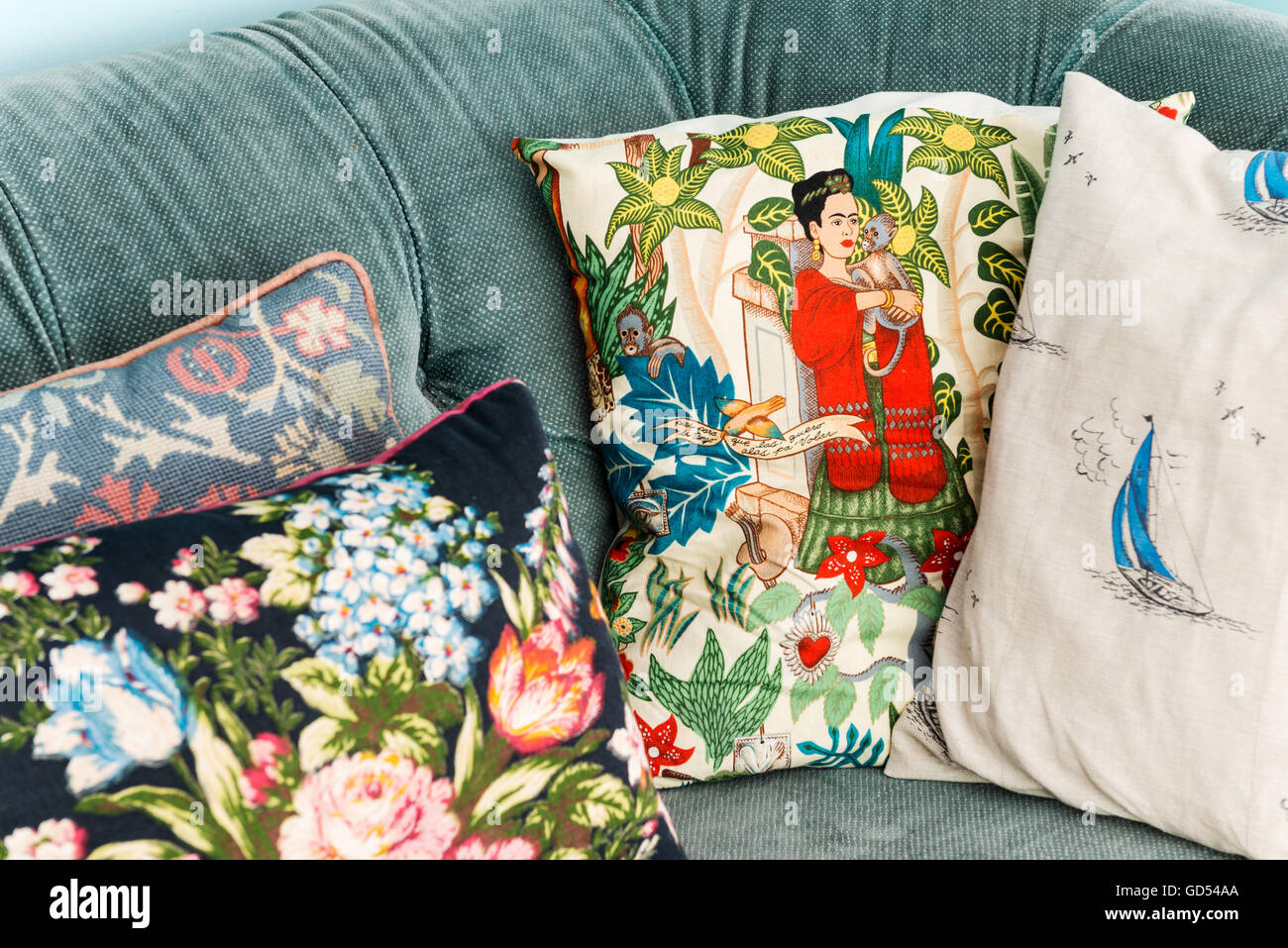A variety of cushions on a velvet chesterfield Stock Photo