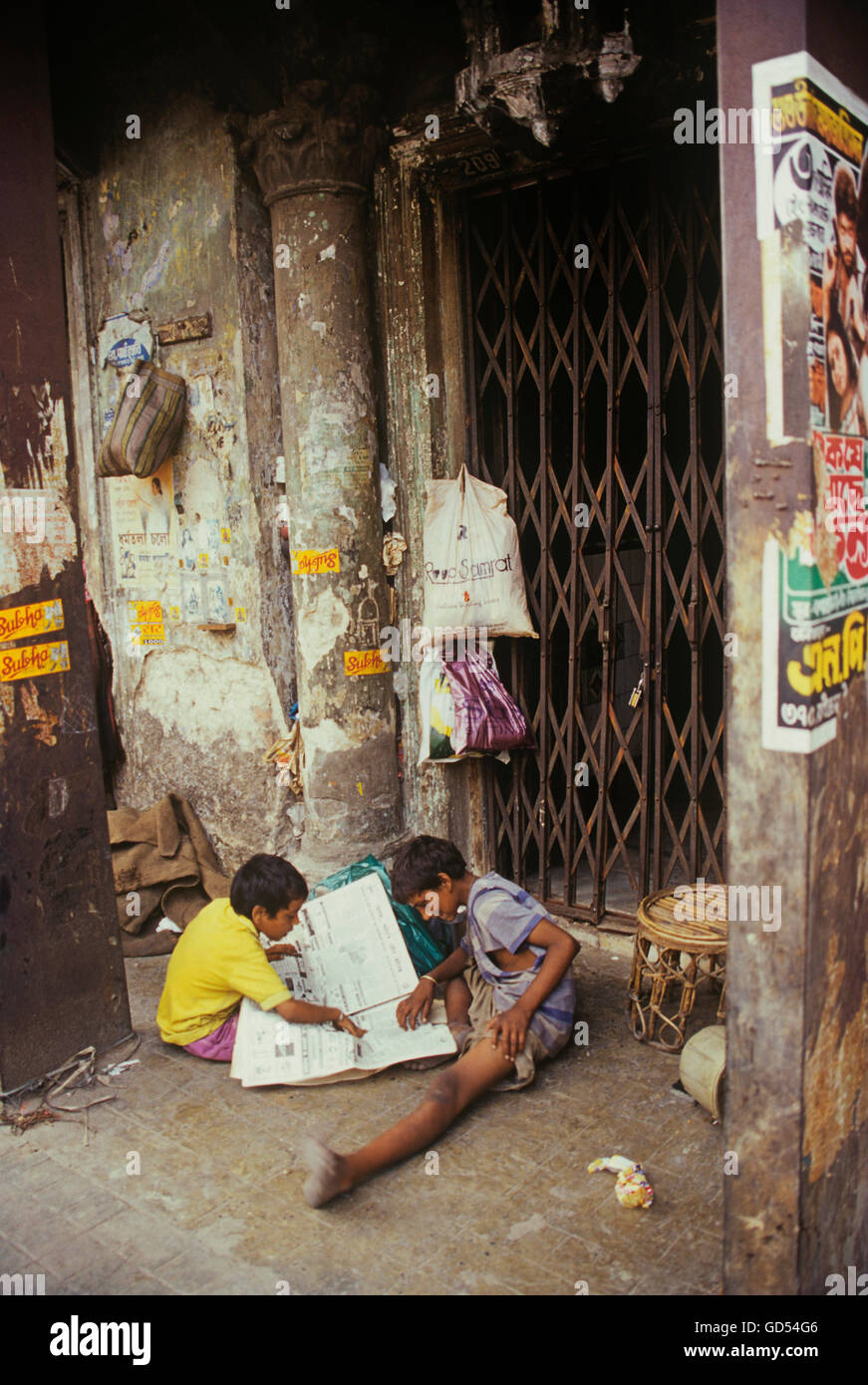 Children reading newspaper on the street Stock Photo