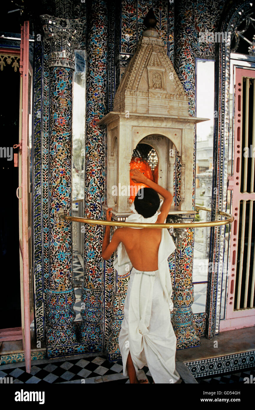 A young priest inside the Jain Temple Stock Photo
