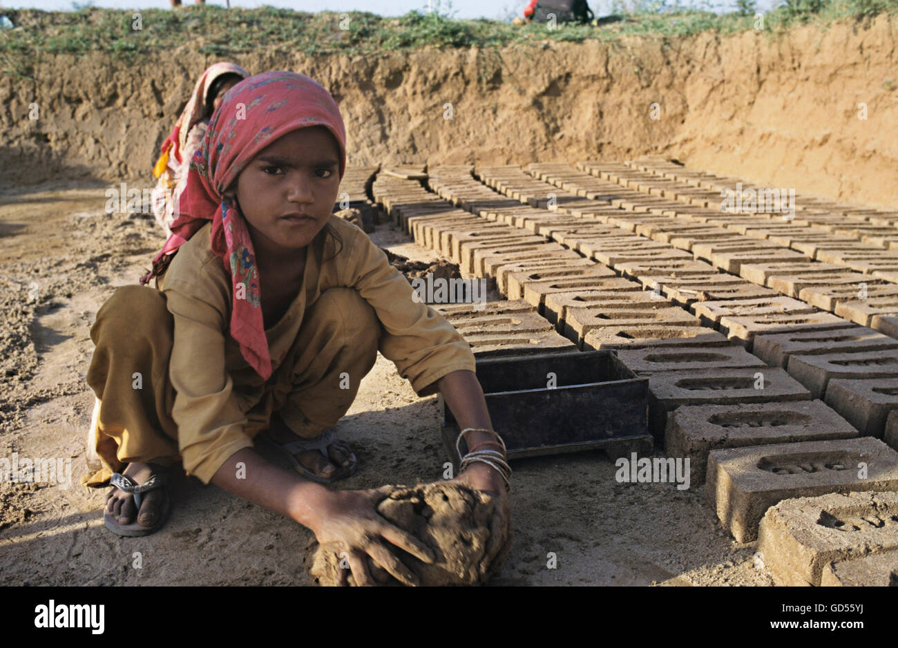 Girl making bricks Stock Photo