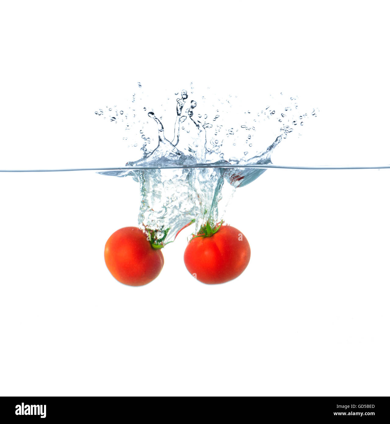 Red Tomato Splash in Water Isolated on White Background Stock Photo