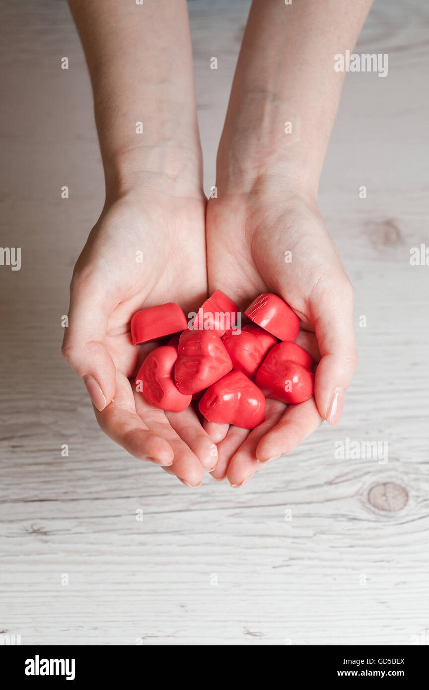 woman's hands full of chocolate sweets Stock Photo