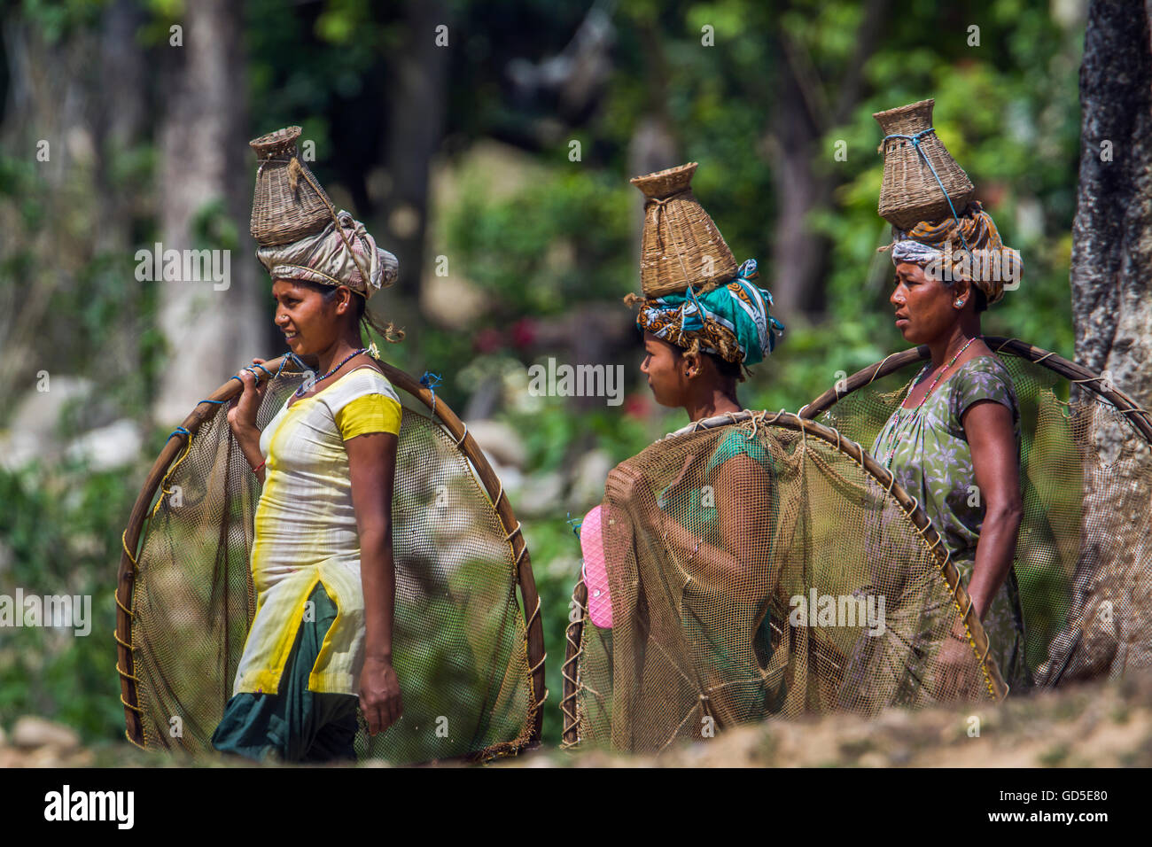 Tharu woman in nepali terai wearing traditional clothing to go fishing Stock Photo