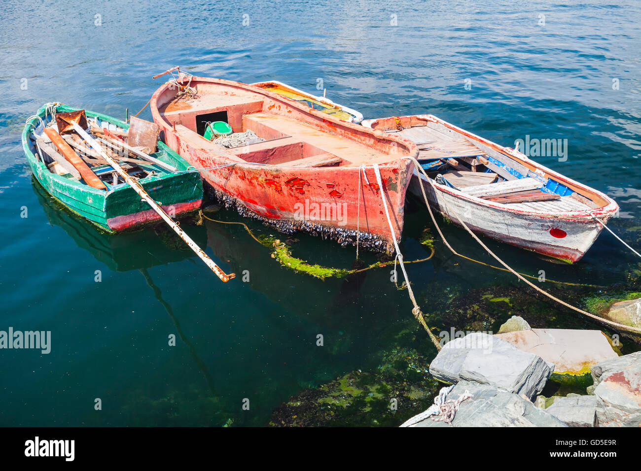 Colorful old wooden fishing boats moored in small port of 