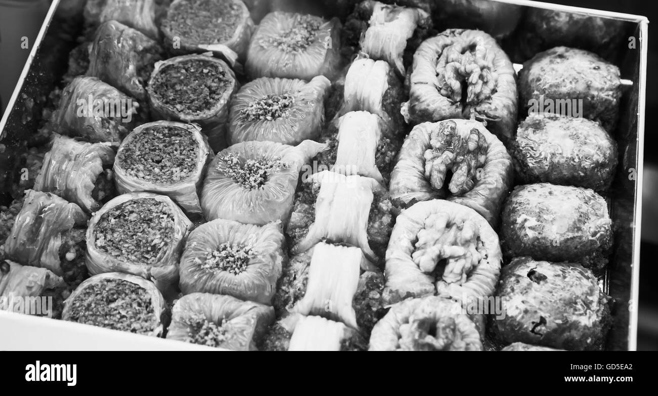 Assorted baklava. Traditional cuisines of former Ottoman Empire and Middle East. Black and white photo with selective focus Stock Photo