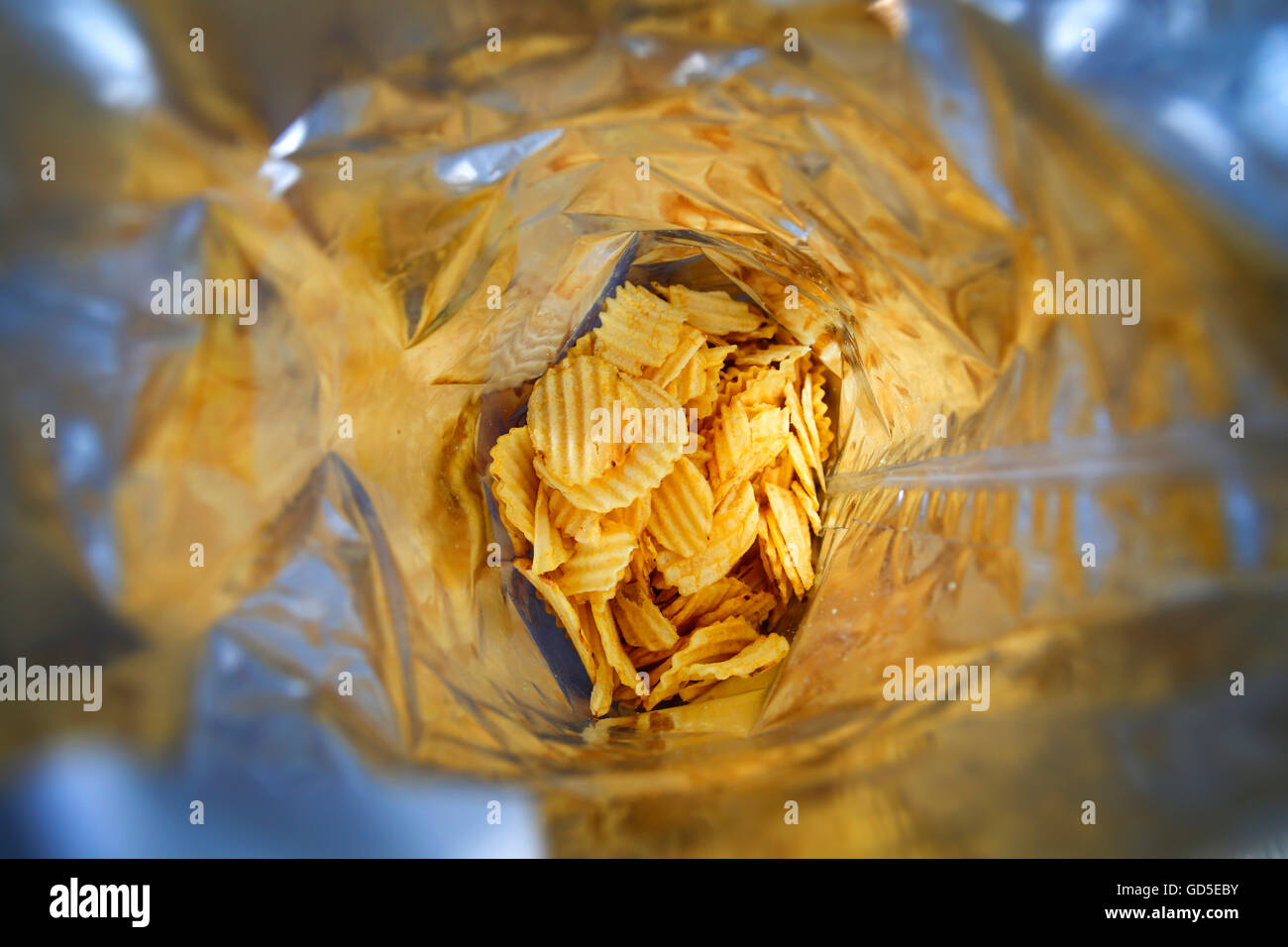 Looking into a half empty bag of potato crisps Stock Photo Alamy
